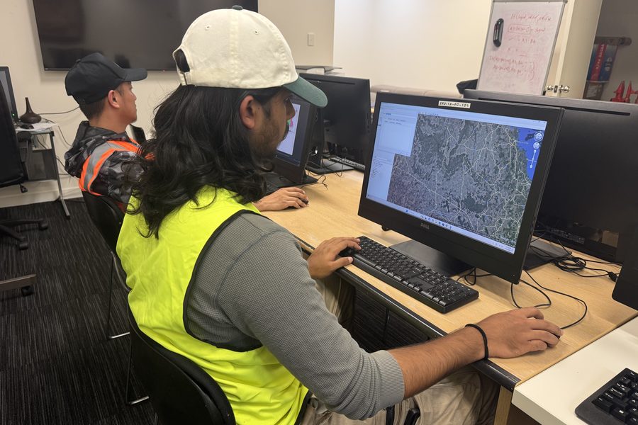 A student studying aerial imagery on a computer in the SRDITA training room