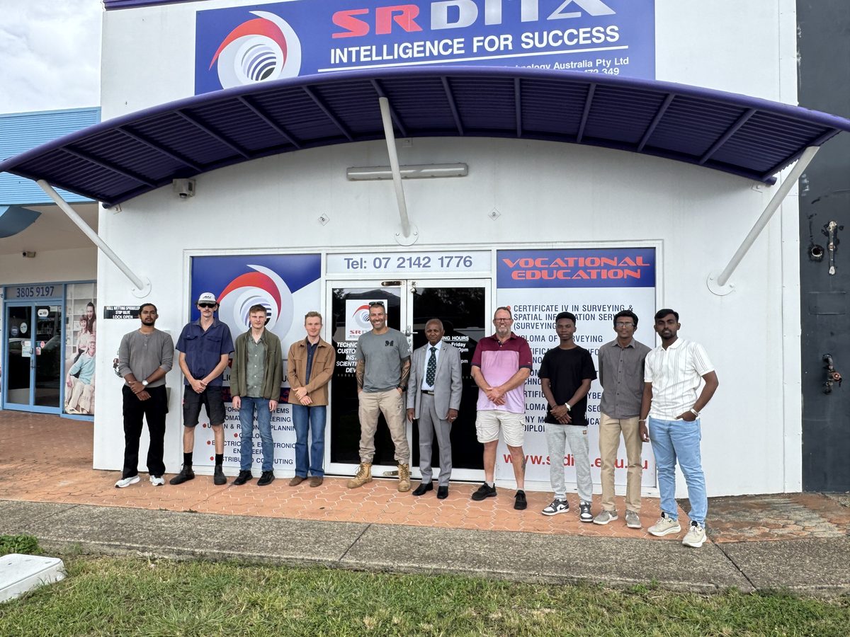 People standing outside the SRDITA entrance at 8/11 Logandowns Drive, Meadowbrook